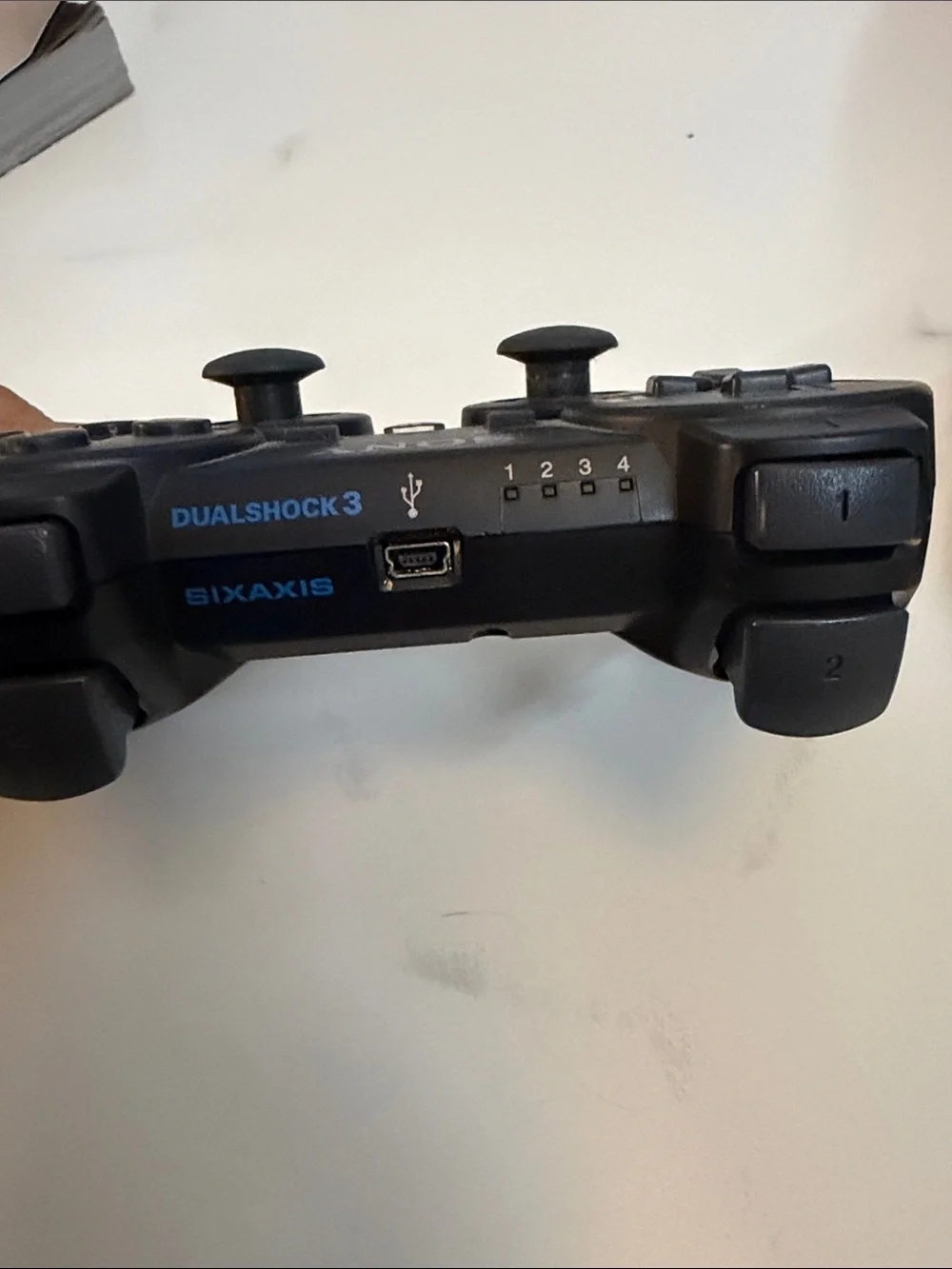 Sony Black Wireless PlayStation Controller with Iconic Button Colors